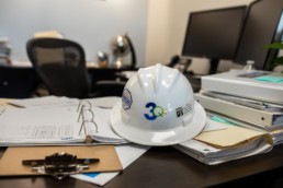 3QC hard hat on desk
